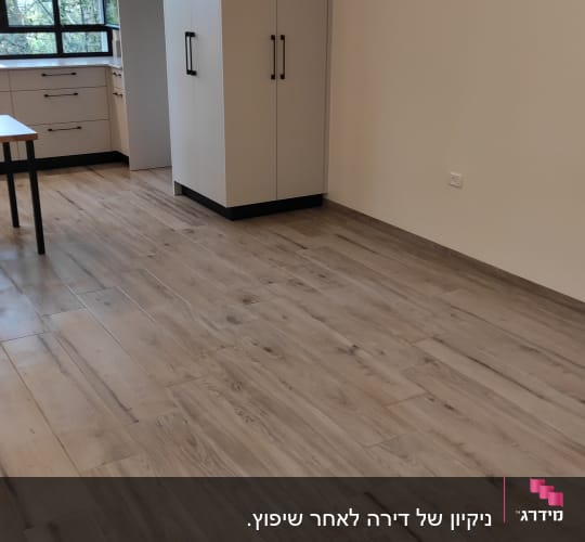 רצפה נקייה מעץ בחדר עם ארונות לבנים